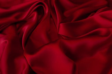 Kırmızı kumaş dokusu arka plan. İpek saten katlanır. Pürüzsüz, zarif duvar kağıdı.
