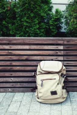 Hipster backpack at sunset background. Tourist traveler bag