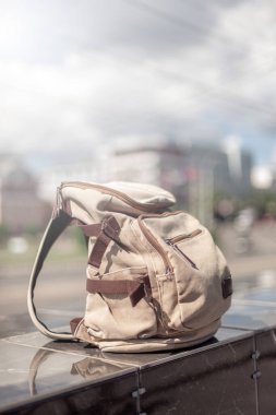 Hipster backpack at sunset background. Tourist traveler bag