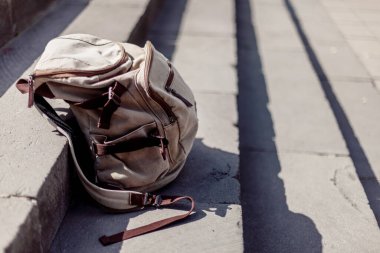 Travel concept. Vintage hipster backpack. Summer city street