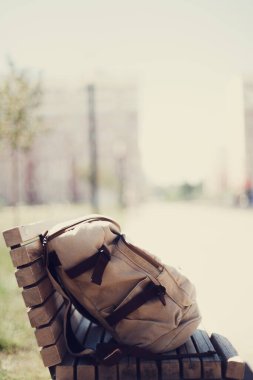 Travel concept. Vintage hipster backpack. Summer city street