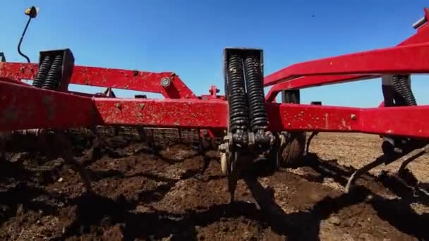 Cultivator plows the ground on the field — Stock Video
