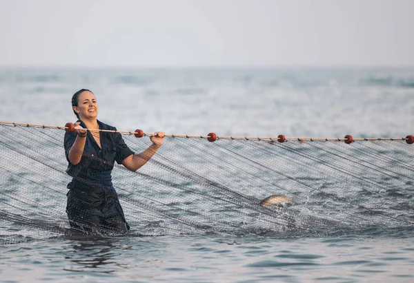 woman fishing with a net. young woman fishing