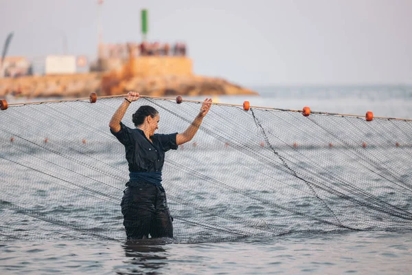 woman fishing with a net. young woman fishing
