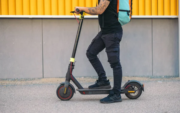 unrecognized delivery man on electric scooter