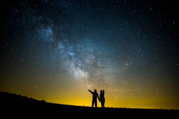 Milky way and couple in Serra Del Montsec, Lleida, Spain.