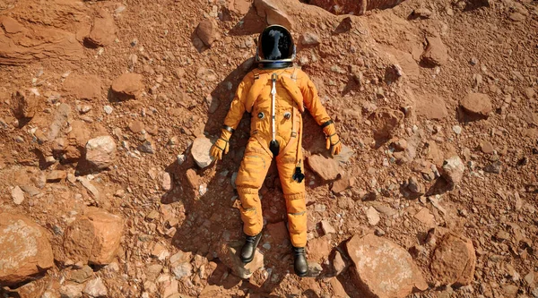 An astronaut laying down on the ground of red planet and relaxing, 3d rendering