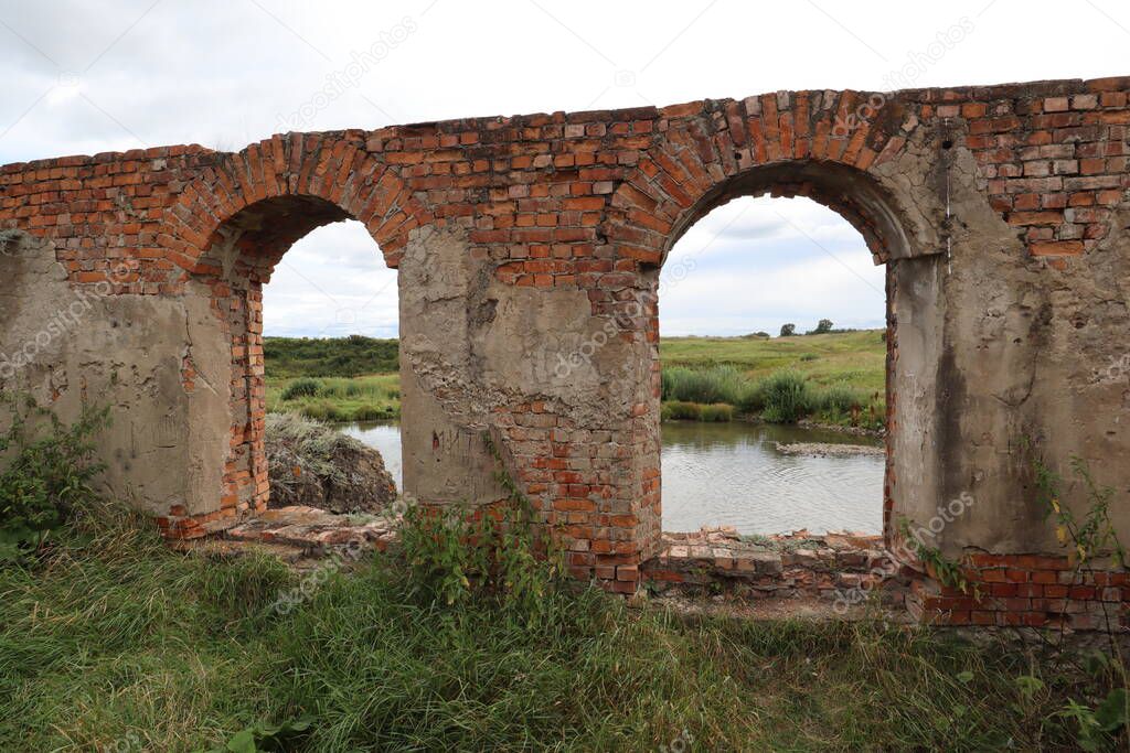 Ruins of an inactive hydroelectric power plant on the river