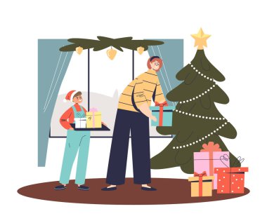 Anne ve oğul Noel ağacının altına Noel hediyesi kutuları koyuyorlar. Kış tatili kutlamalarına hazırlanıyorlar.