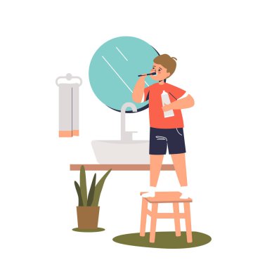 Diş fırçası ve diş macunuyla aynada aynaya bakan sevimli çocuk.