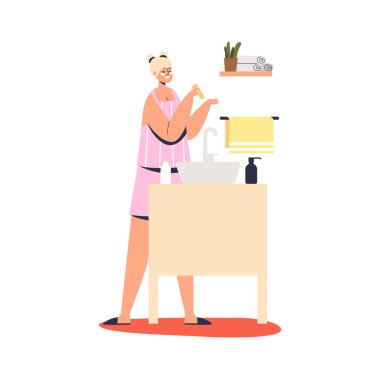 Genç bir kadın gece cilt bakımı için aynanın karşısına cilt kremi sürüyor.