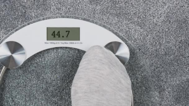 Bathroom scales with LCD screen saying Overweight — Stock Video