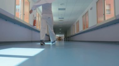 Doctor walking down the hospital corridor.