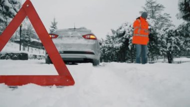 Driver call technical assistance on the road in winter.