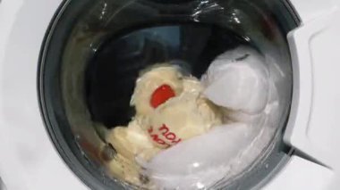 Teddy Bear plush toy in washing machine.
