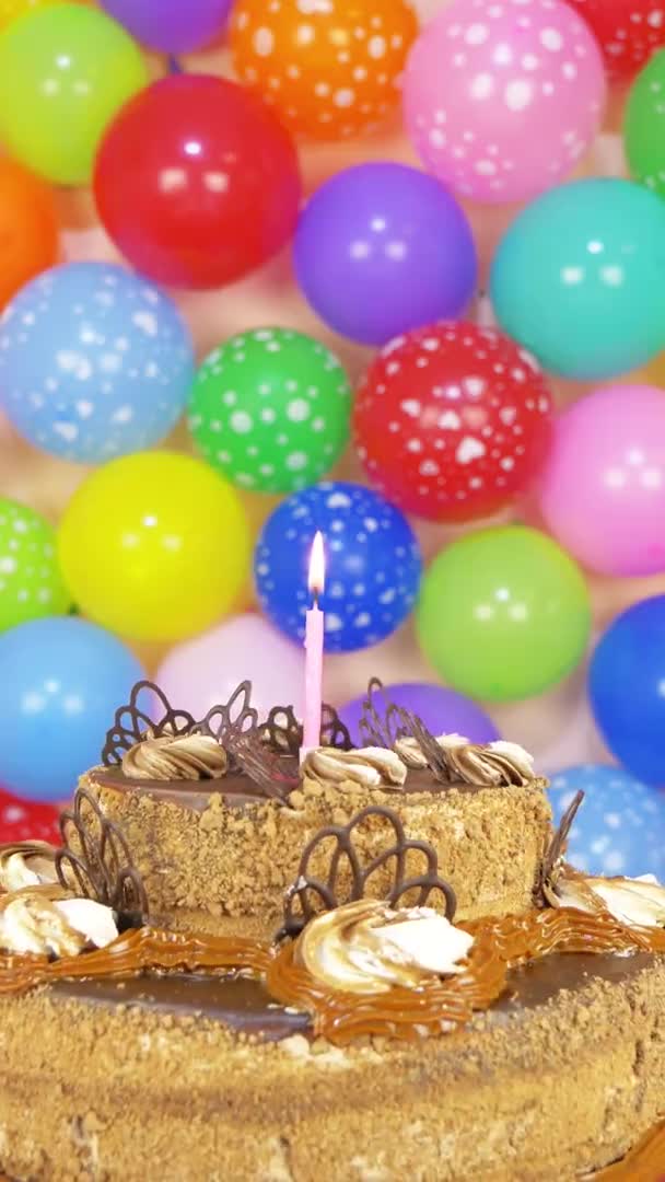 One Candle Chocolate Cake Varicolored Festive Balloons Background Vertical Footage — Stock Video