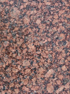 Parlak bir yüzeyi ve pürüzsüz doğal taş dokusu dikey görüntüsü olan granit bir parça. İç tasarım, endüstri ve dekorda kullanılmak üzere mermer arka plan.