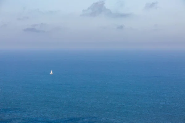 Hazy View Out Sea Distant Sailing Boat Calm Ocean — ストック写真
