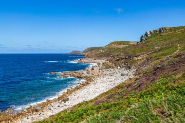 The rugged Cornish coast with a blue sky overhead