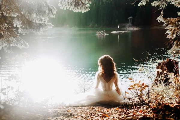 Genç gelin gölün kenarında oturuyor.