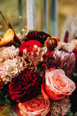 Boho tarzında bir düğün töreni. Bir buket gül ve yıldız çiçeği.