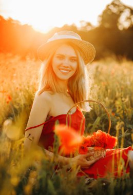 Hasır şapkalı sarı saçlı çekici kız haşhaş tarlasında poz veriyor..