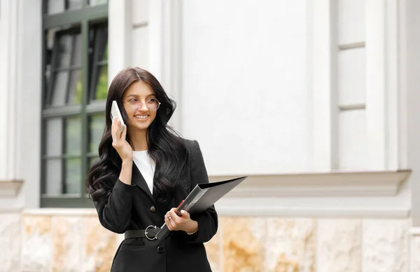 Woman Calling on Phone  Portrait of Beautiful Smiling Female Talking on Phone Outdoors. Girl wiht Smartphone.