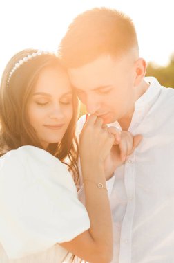Photo of a man kissing the hand of his wife who reciprocated. Marriage proposal. She said yes.