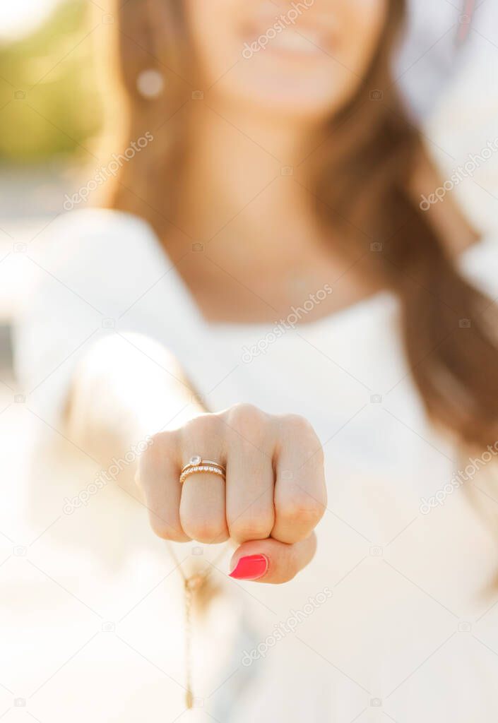 Photo of man making proposal to his amazed woman with ring in gift box while walking on sunny beach