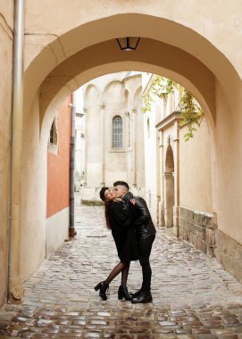Young couple hugging in the yard of the old town. November 2, 2019, Lviv, Ukraine.