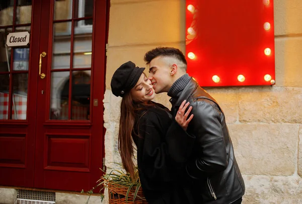 Sweet couple boy and girl hugging in the rain. Concept of love, romance and passion. November 2, 2019, Lviv, Ukraine.