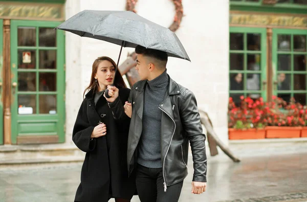 Sweet couple boy and girl hugging in the rain. Concept of love, romance and passion. November 2, 2019, Lviv, Ukraine.