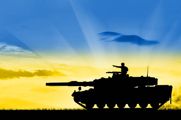 A Ukrainian military tank goes on the attack against the background of the sky in the form of the Ukrainian flag - a silhouette. Concept of crisis and war between Ukraine and Russia