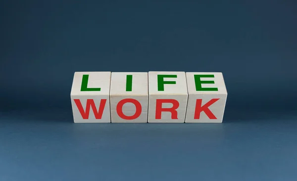 Life or work. The cubes form the choice words Life or Work. Concept of balance between leisure and business.
