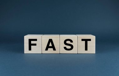 Fast. Cubes form the word Fast. An extensive concept of fast applied in different areas of life