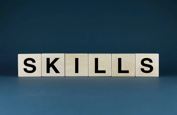 Skills. The cubes form the word Skills. The broad concept of the word Skills is used both in business and in life.