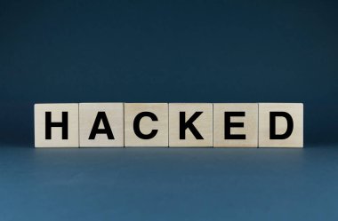 Hacked. Cubes form the word Hacked. The concept of the word Hacked - data, account, computer and so on