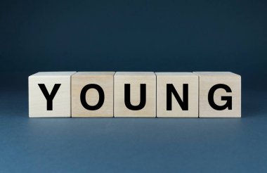 Young. Cubes form the word Young. The concept of the word Young - period of life and lifestyle