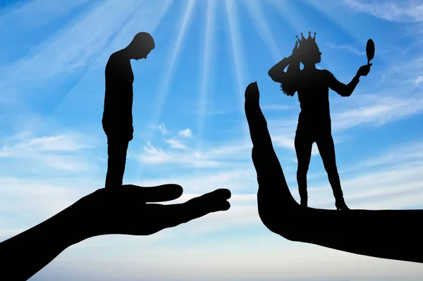 Selfishness, narcissism and arrogance. A distressed man and an arrogant woman with a crown standing on her hand stop. Concept of selfish behavior and lack of compromise in relationships. Silhouette