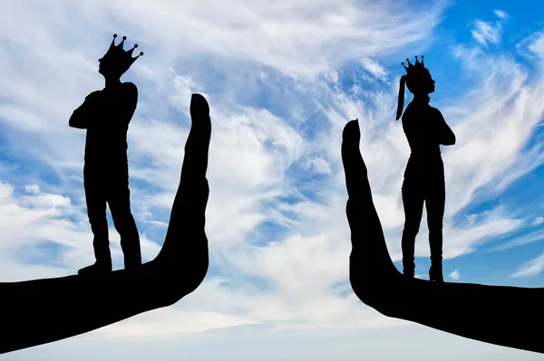 Selfishness and arrogance. Arrogant people, a woman and a man with a crown stand turned away on their hands - stop. Concept of arrogant behavior and the lack of compromise in relationships. Silhouette