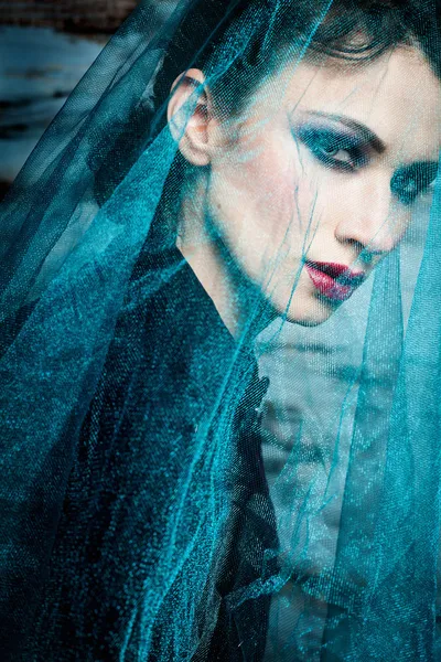 Beautiful woman under blue veil — Stock Photo, Image