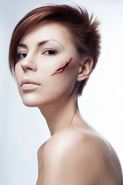 Girl with a cut on face — Stock Photo, Image