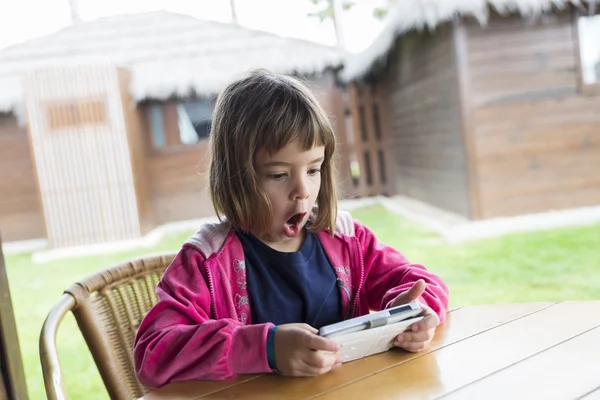 Little girl with a smartphone — Stock Photo, Image