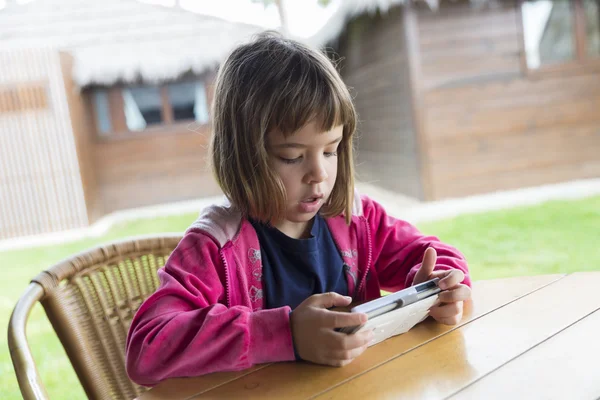 Little girl with a smartphone — Stock Photo, Image