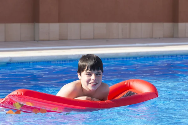 Young boy in a swimming pool — Stock Photo, Image