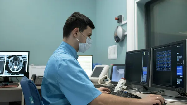 Оператор МРТ робить процедуру сканування мозку пацієнта. — стокове фото