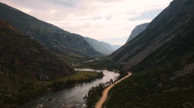 Vadideki dağların arasından nehrin üzerinden uçuyor. Altai.