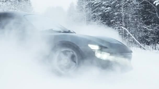 MOSCOW, RUSSIA - 13 DECEMBER 2020: A black sports car is drifting in the forest. Slow motion — Stock video