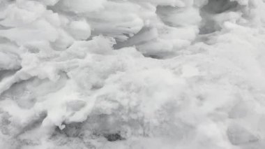 A close-up of the snow-covered surface of one of the weathering pillars in the Komi Republic, Russia. One of the seven wonders of Russia. Giants of the Manpupuner Plateau. Geological monument in the Troitsko-Pechora region.