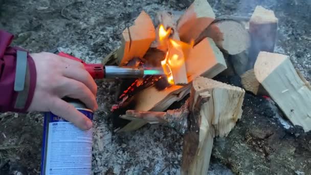 Man Kindles Fire Gas Cutter Burning Firewood Logs Yellow Orange — Stock Video